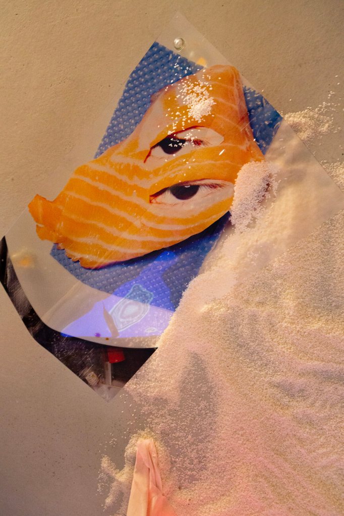 Across the ocean - Installation with video - part of "Made in Rice", printed silk fabrics, acrylic glasses, rice, chains and diverse objects. Hien Hoang, 2022, Munich, Germany.