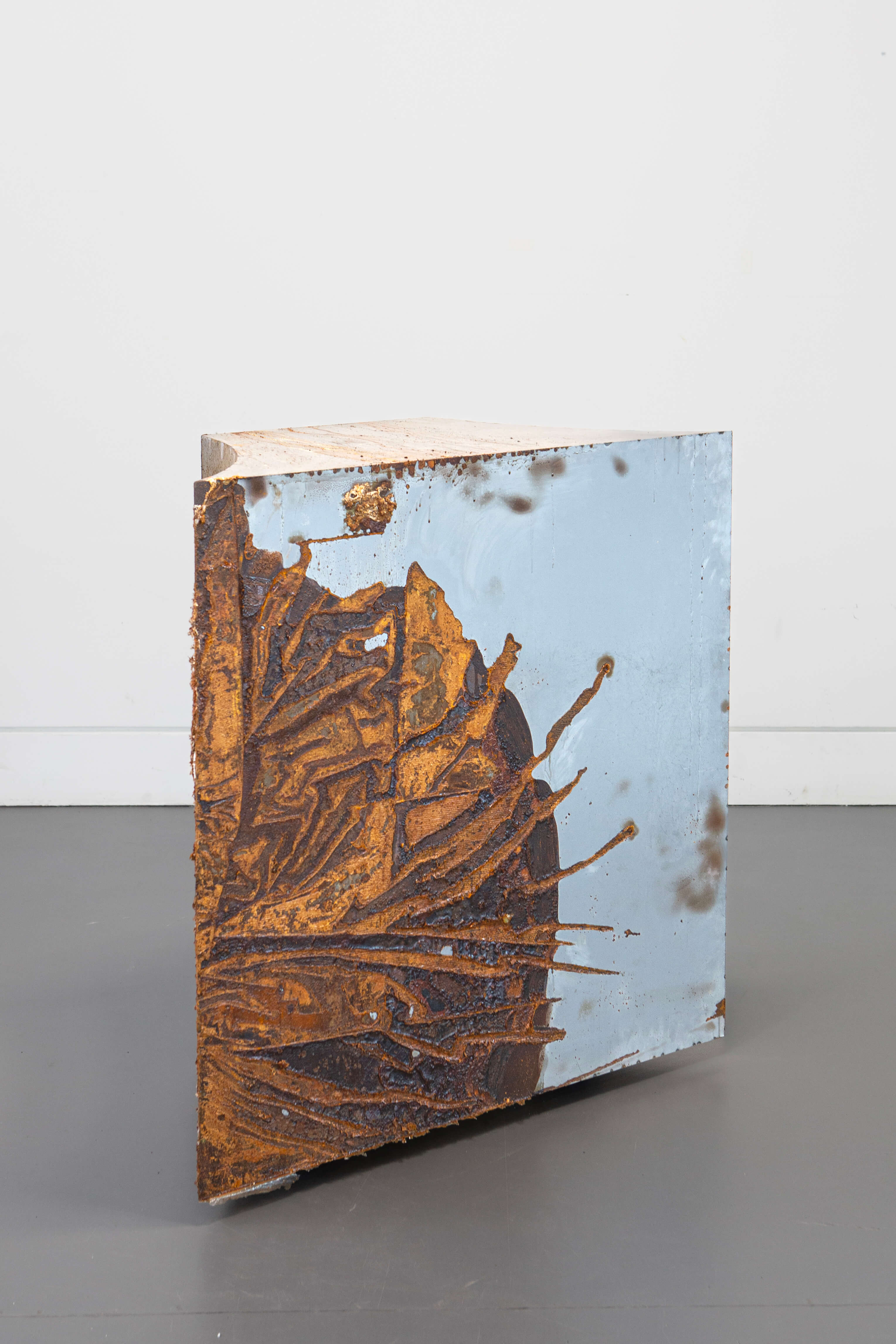 Hiền Hoàng, The Base, part of Slow Sculpture (2026–ongoing), corroded steel, 90 × 90 × 45 cm, back side view.